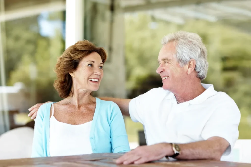 Senior couple relaxing and talking together on a patio table