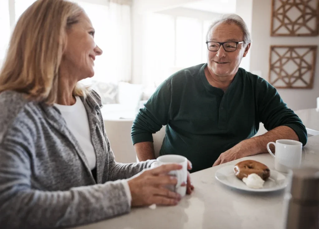 Senior couple having coffee and breakfast together at home