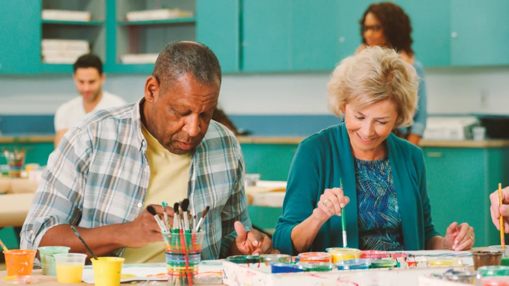 Group of seniors painting in activity room