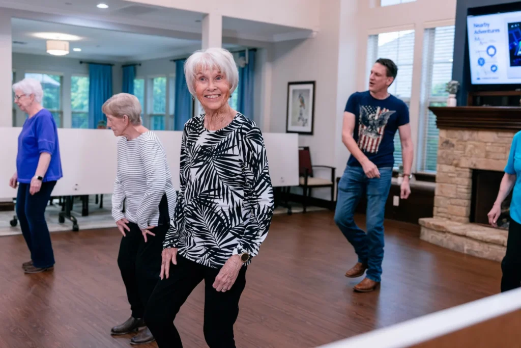 Seniors dancing together in the activity room